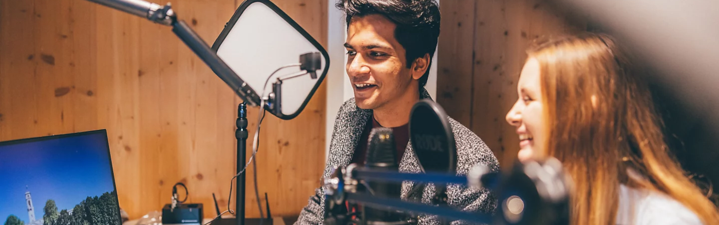 Two people in recording studio, smiling