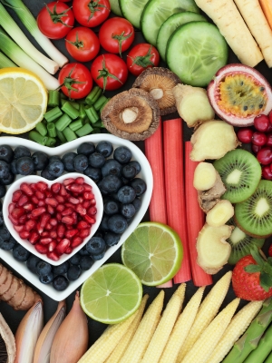 A number of different fruit and vegetables arranged into a heart