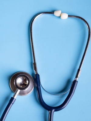 A stethoscope with a blue background, symbolizing medical care and health services