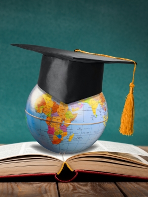 An earth globe wearing a graduate hat