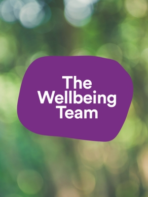 A purple logo with the words wellbeing services on it