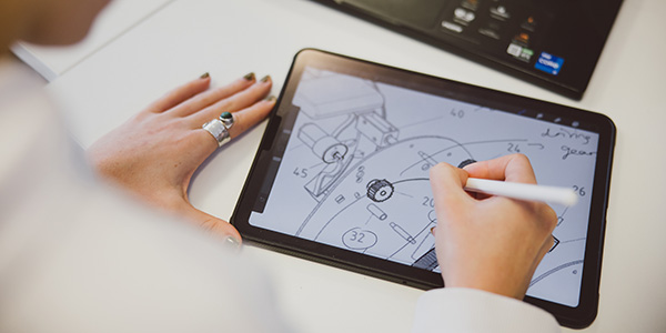 A student working on a design drawing on their tablet