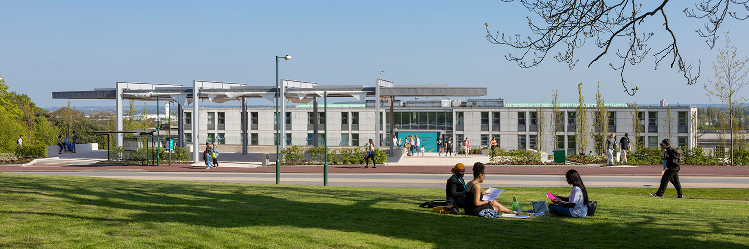 students sitting on the grass in front of Portland building