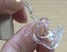 How do I clean my hearing aid earmould and tubing?