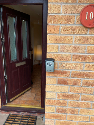 A photo of the outside of the patients front door - displaying the key safe.