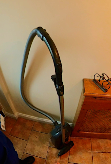 Hallway Hazard - A picture of a vacuum cleaner which is obstructing the hallway entrance.