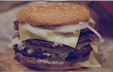 An image of a fried burger and bun to demonstrate poor diet.