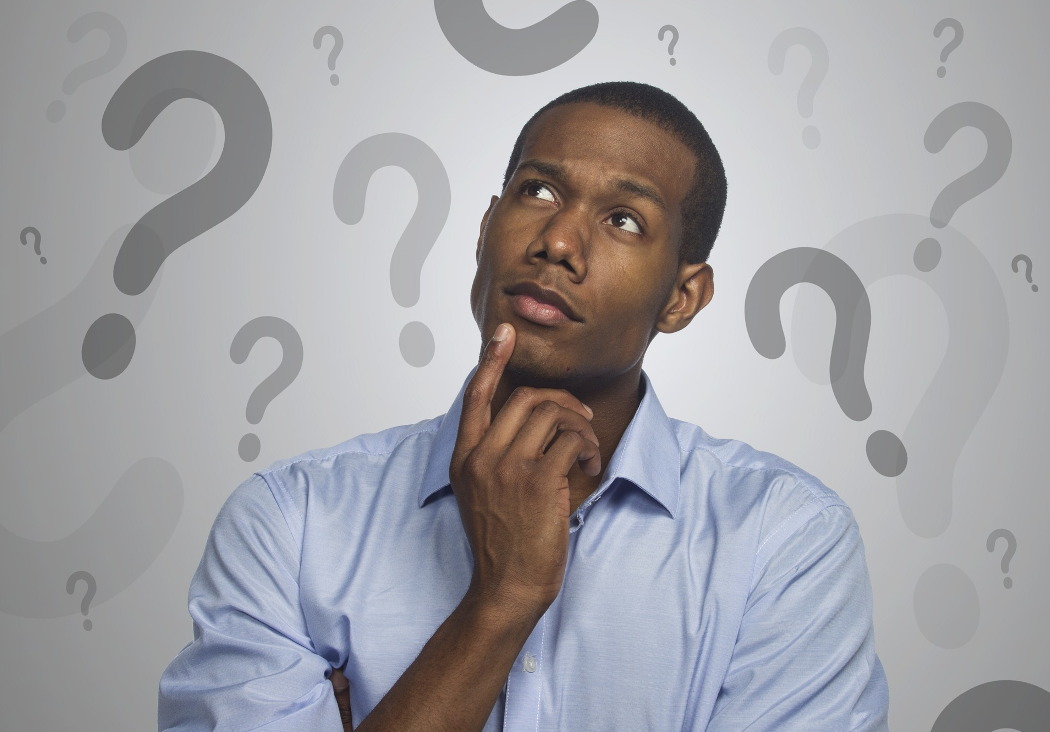 A picture displaying man with puzzled face and question marks all around.