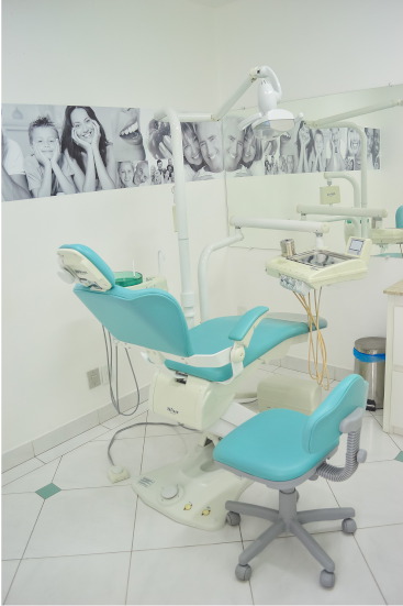 A picture of dentist surgery, with welcoming pictures of family smiling on the walls.
