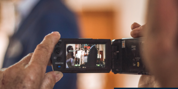 A photo of a person's hand holding a video recorder