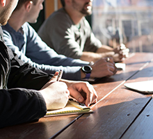 people with their hands on a table