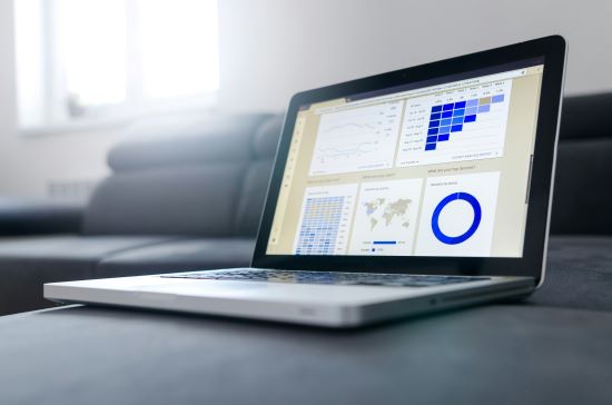 Laptop showing series of data graphs on screen