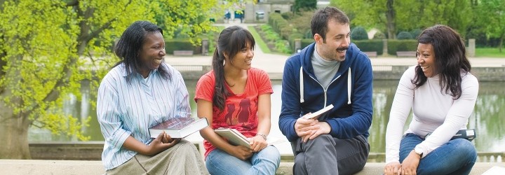 Students sitting outside on campus