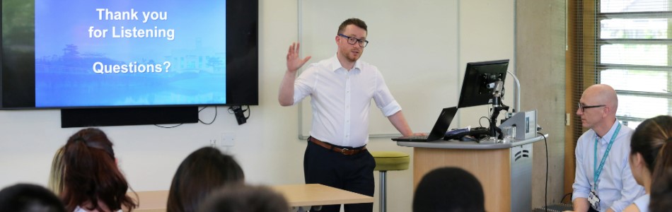 An academic delivering a presentation to an audience.