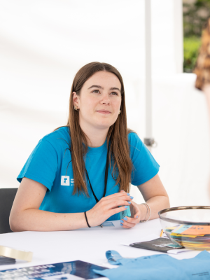 A student ambassador sat at a subject information stand