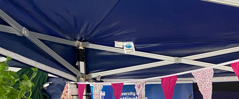 Two women hosting a stall at Green Hustle festival with colourful bunting