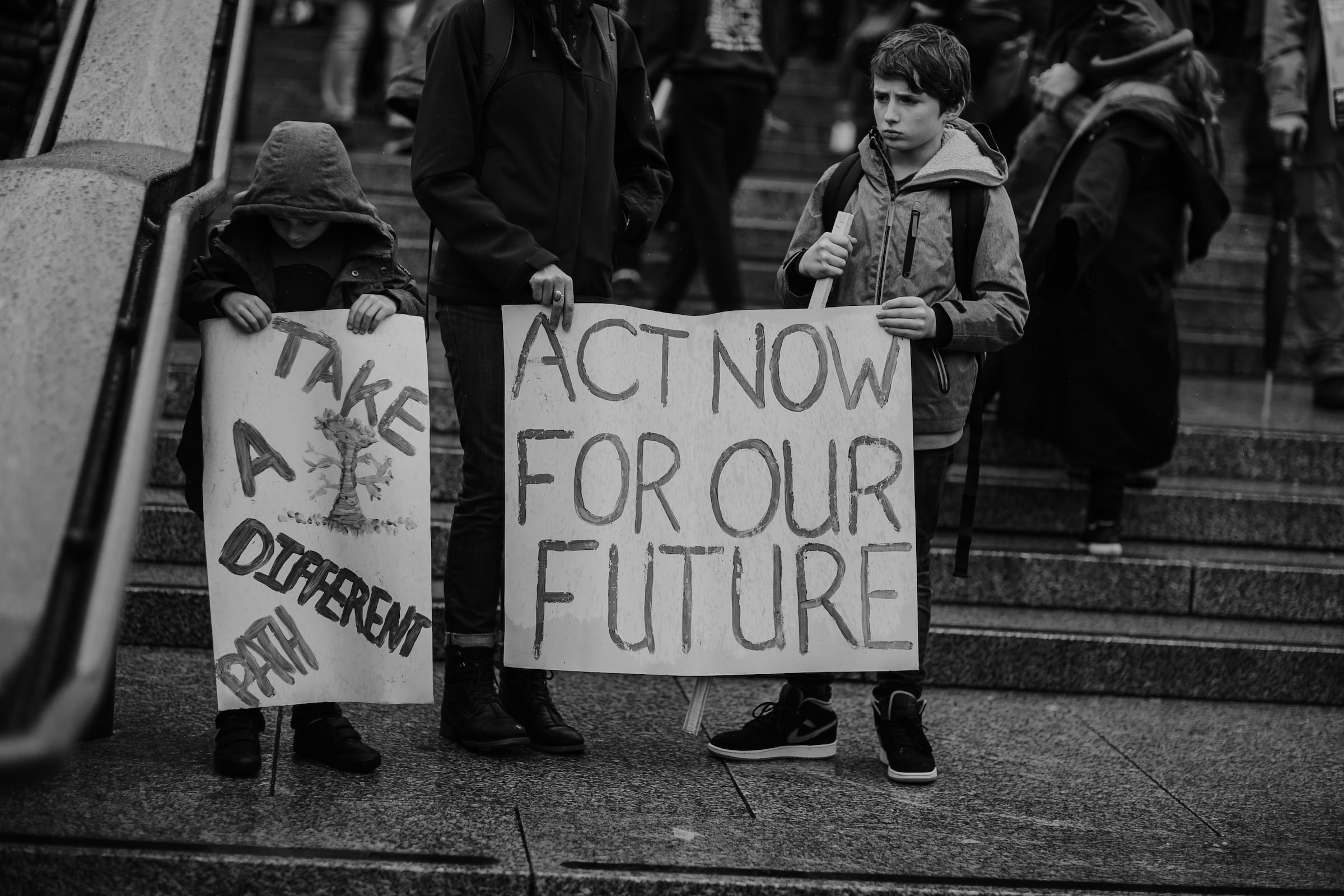 Children at Extinction Rebellion climate protests in London holding a sign saying 'Act now for our future'