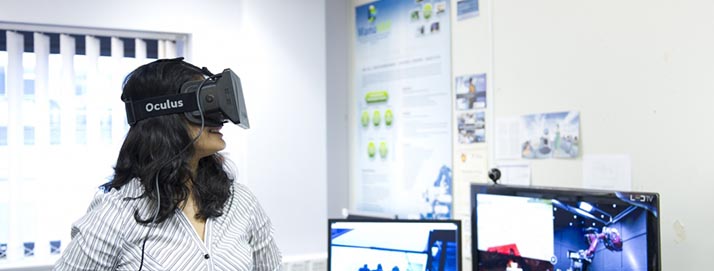 Member of staff wearing an Oculus VR headset.