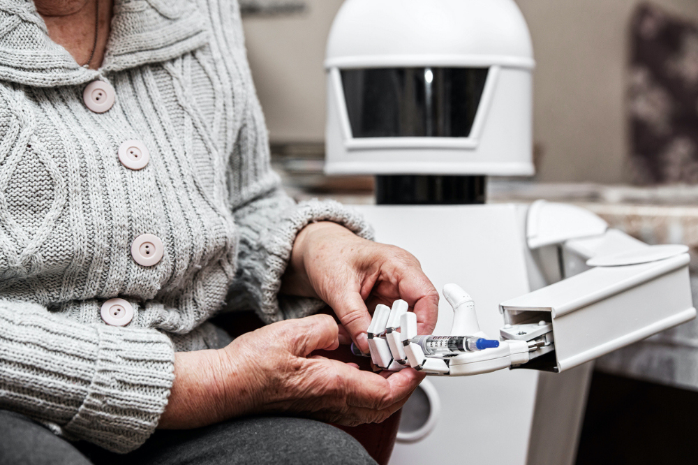 Robot holding syringe for person in knitted cardigan
