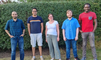 5 members of the Bhosale Lab standing outside