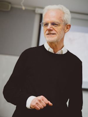 Half body portrait of Professor Richard Bell in lecture theatre, smiling