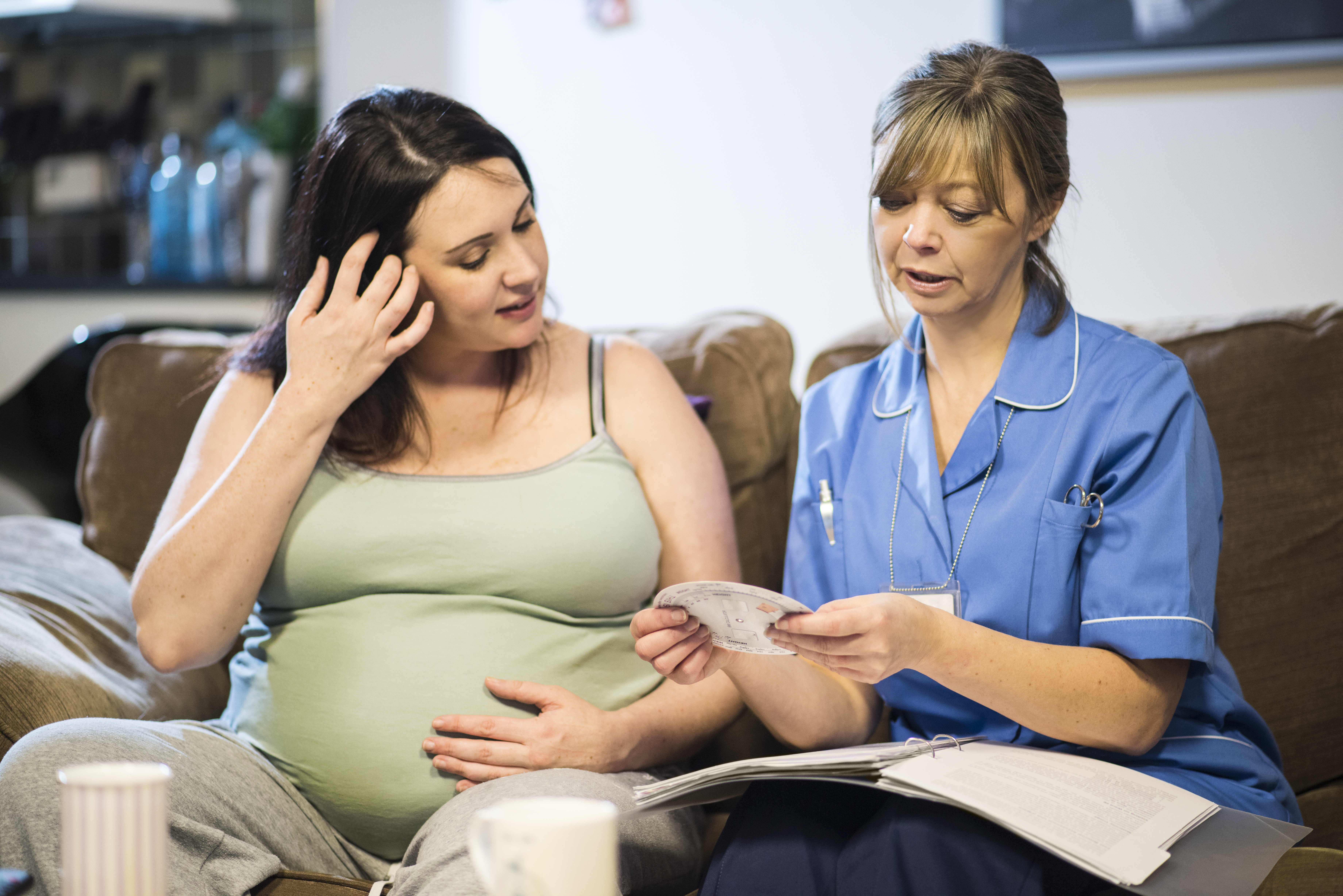 Nurse talking to pregnant patient