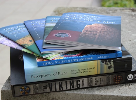 Pile of books and journals about the Vikings stacked on top of a stone plinth (photo)