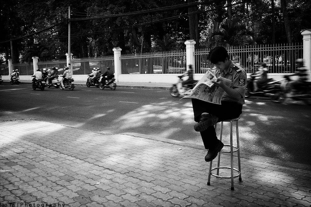 Man reading news on the street