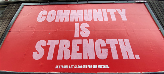 Billboard saying "Community is strength"