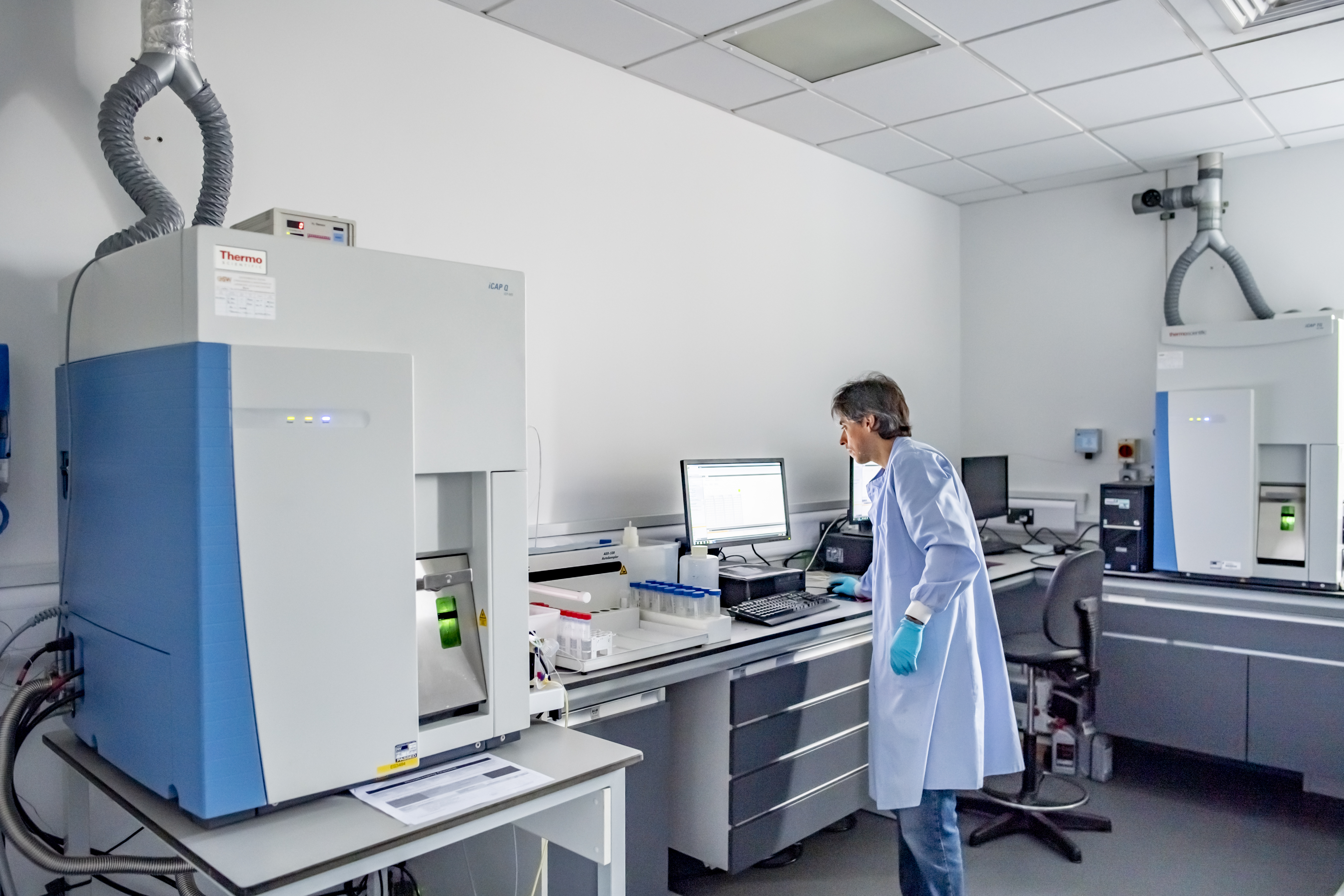 Technician operating equipment in the lab