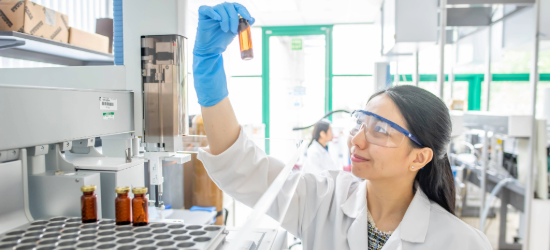 Photo of a researcher assessing a food sample bottle