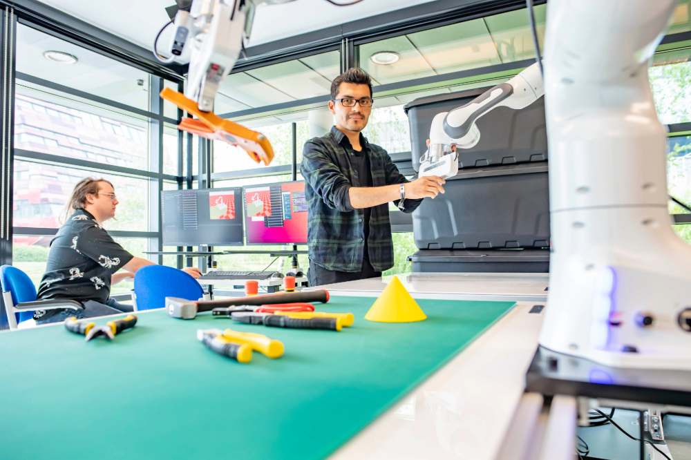 Technical staff sitting on the floor at the Robot Lab