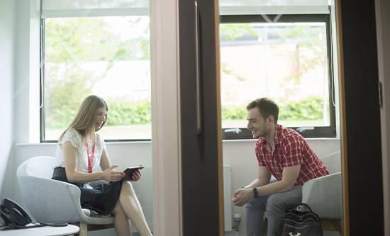 Two students seated in discussion