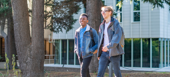 Two students walking around campus together.