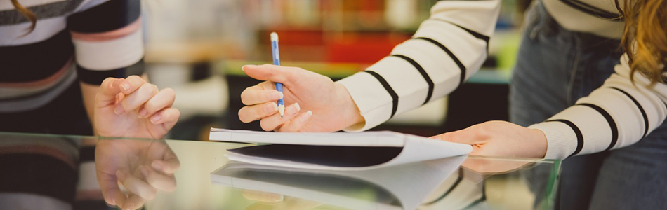 Two students working together on a table