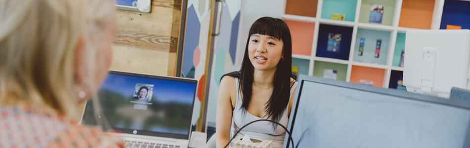 Student talking to a member of staff in a student services centre