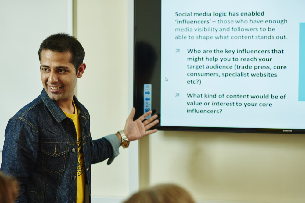 An student presenting to people on their course