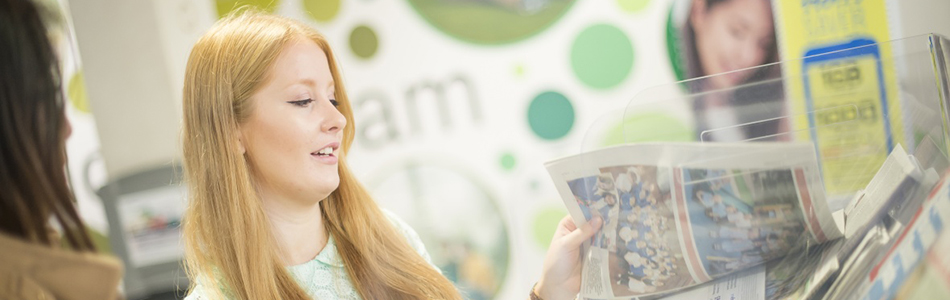 Student looking through a newspaper