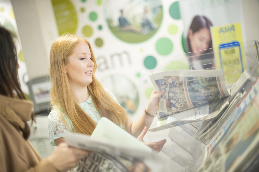 Students picking up newspapers