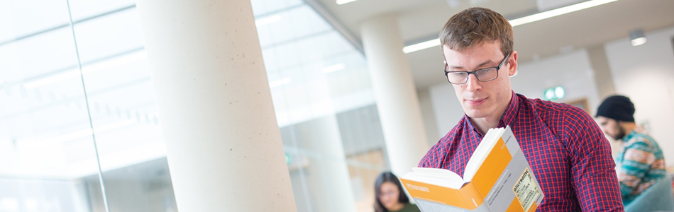 Student reading a book in George Green Library