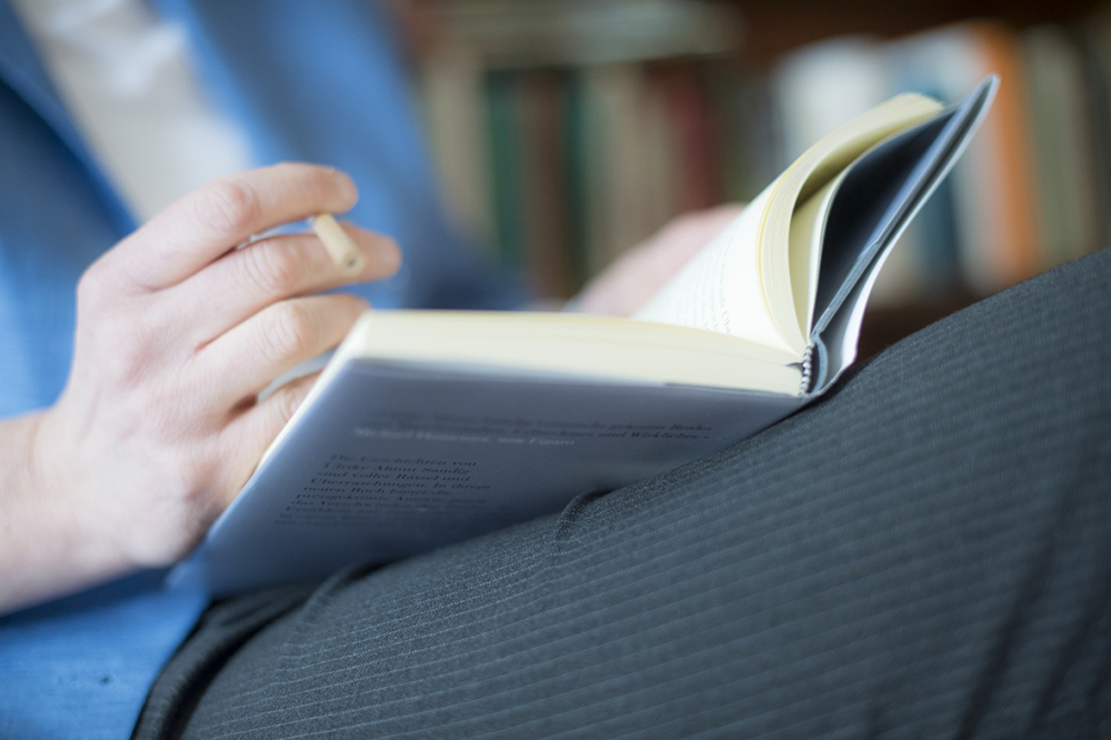 Academic member of staff reading a book