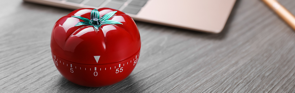 Pomodoro timer next to a laptop