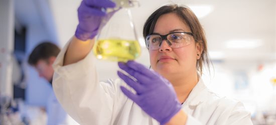 Professor Rachel Gomes looking at chemicals in a laboratory