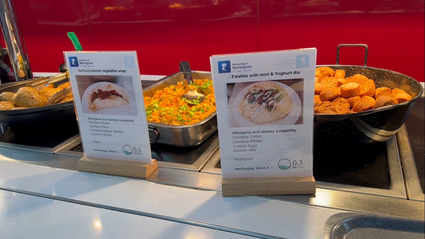 Labelled food menus in front of a food station